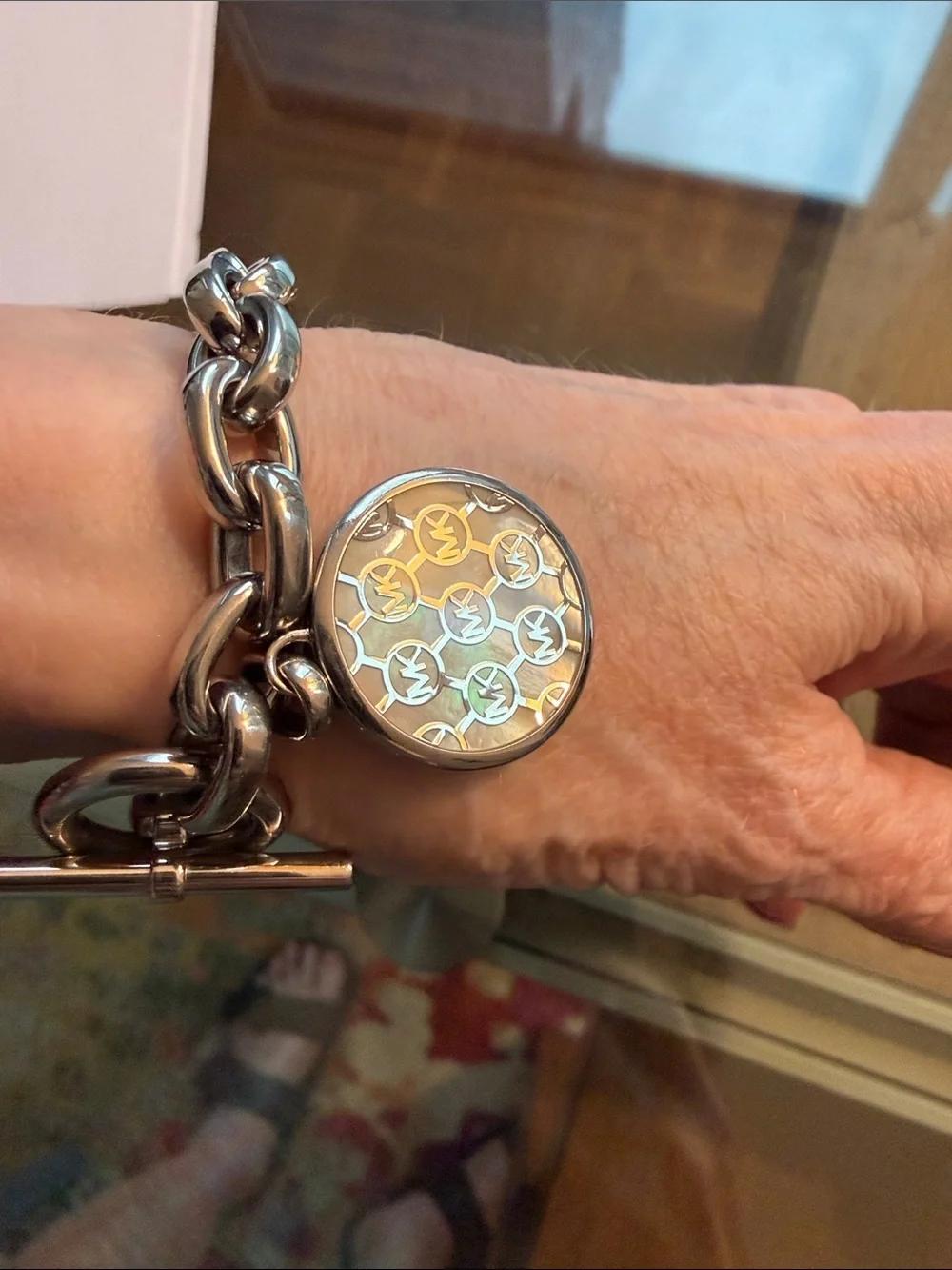 Michael Kors Silver-tone Toggle Bracelet with Dual Sided Logo Charm.